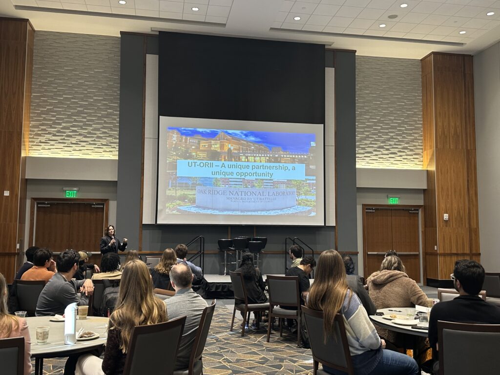 UT-ORII's interum executive director, Brynn Voy, speaking to potential students at the 2026 Recruit Visit. PowerPoint with ORNL behind her.